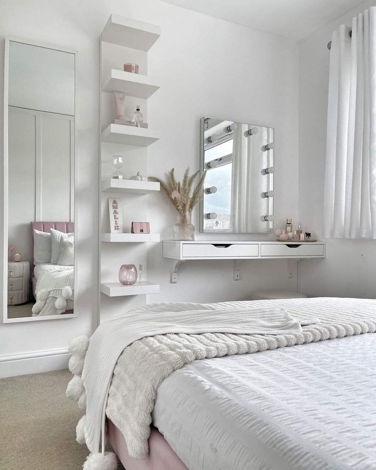 a bedroom with a bed, mirror and shelves on the wall next to it's windows