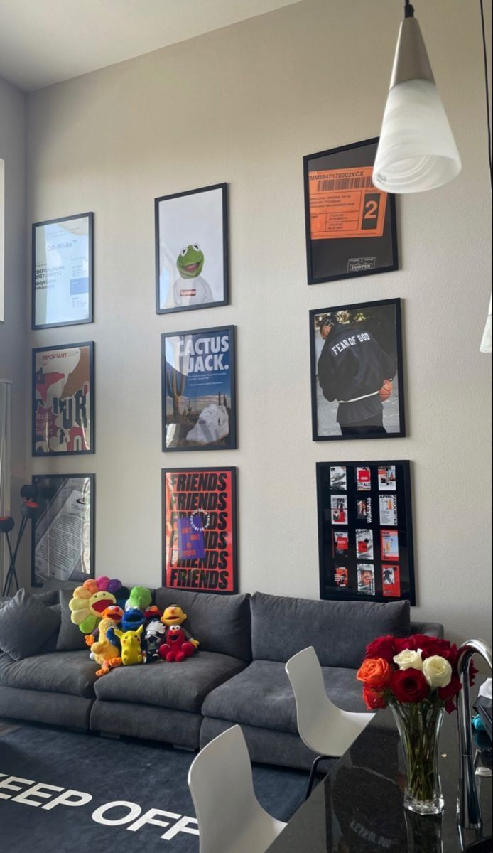 a living room filled with furniture and pictures on the wall