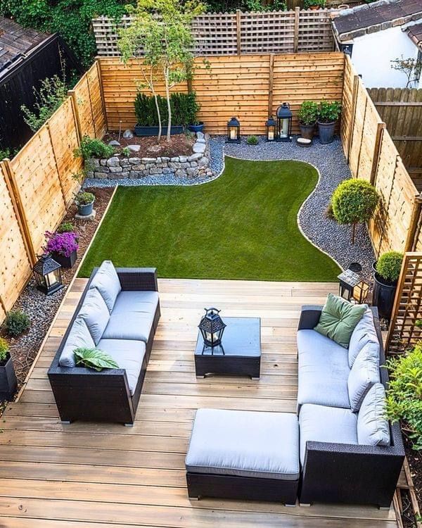 an outdoor living area with couches, tables and plants in the middle of it