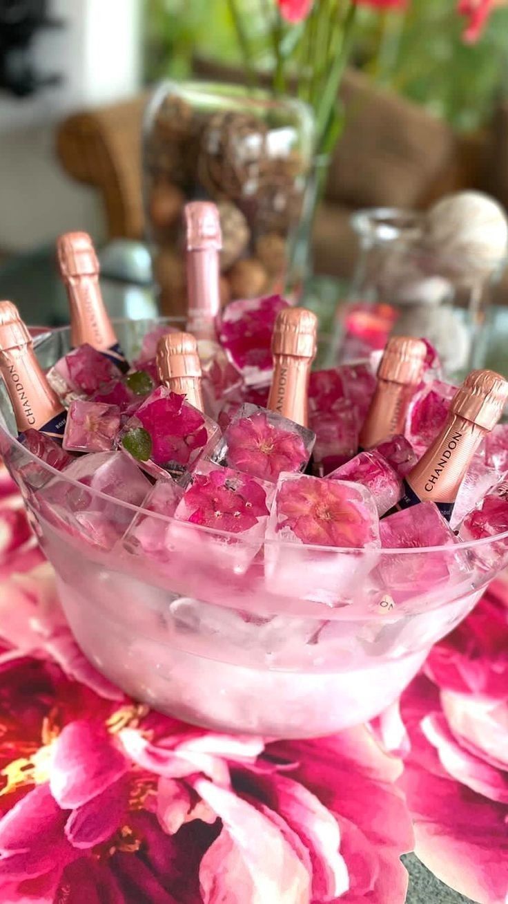 a glass bowl filled with lots of pink flowers