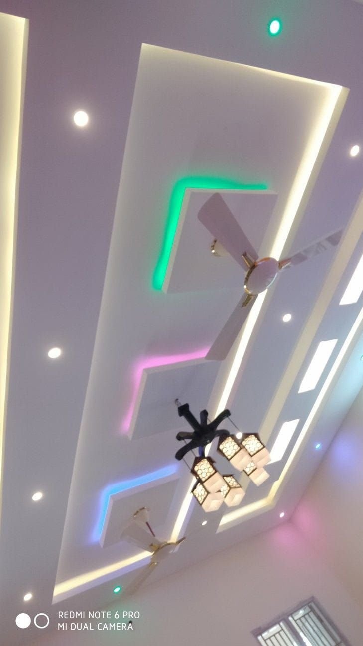 the ceiling is decorated with colorful lights and decorative fixtures, along with an abstract light fixture