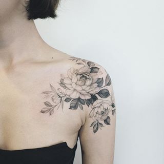 a woman with a flower tattoo on her chest