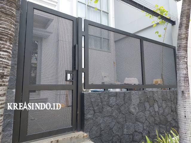 an entrance to a building with a stone wall and metal gate