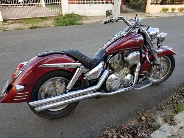 a red motorcycle is parked on the street