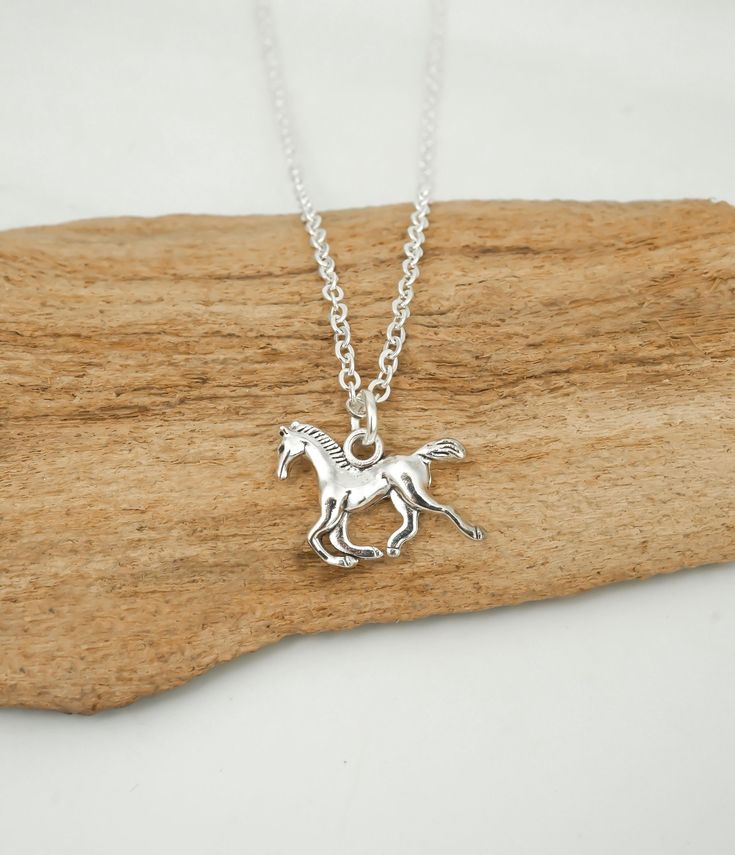 This antique silver horse necklace makes a great gift for young equestrians. This necklace includes: - reversible horse pendant (size 15 mm | 5/8 inch) - silver anchor chain (14 to 36 inches) To Add Initial or Number Charms: https://etsy.me/3RnJ5qD  To Add Birthstone Charms: https://etsy.me/3Zif2Uw We ship twice a week, usually Mondays and Thursdays. To USA: - Provider: Chit Chats Express (who deals directly with USPS) - Arrival Time: 5-10 days (1-3 days for preparation, 5-7 for shipping time) - Tracking: Yes - Ships out from Vancouver, Canada To Canada: (Please note, we have increased our shipping cost to include GST since Etsy no longer allows us to charge this separately.) - Provider: Canada Post - Arrival Time: 10-14 days on average - Tracking: No - Ships out from Vancouver, Canada To Chit Chat, Silver Horse, Horse Necklace, Anchor Chain, Horses Pendant, Horse Jewelry, Pure Gold, Birthstone Charms, Antique Silver