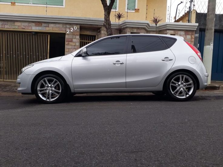 a silver car parked in front of a house