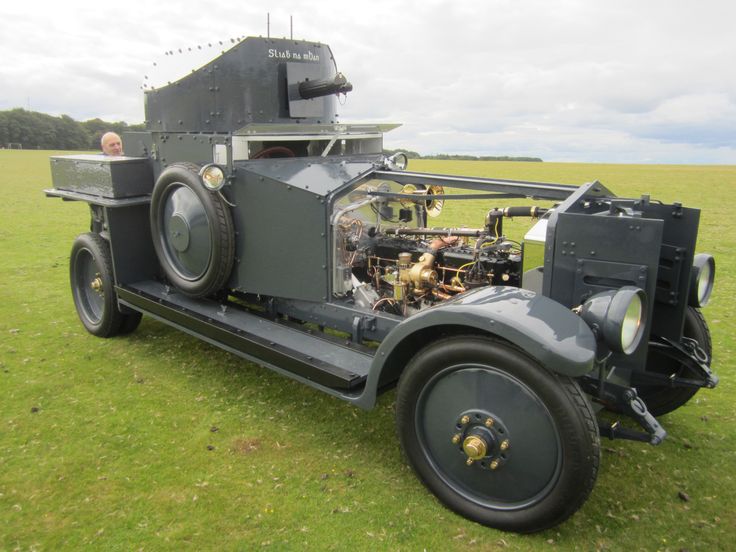 an old car is parked on the grass