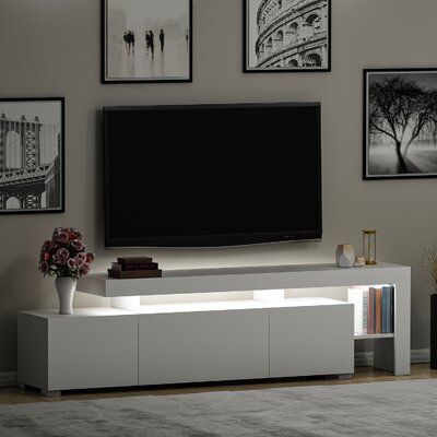 a flat screen tv sitting on top of a white entertainment center