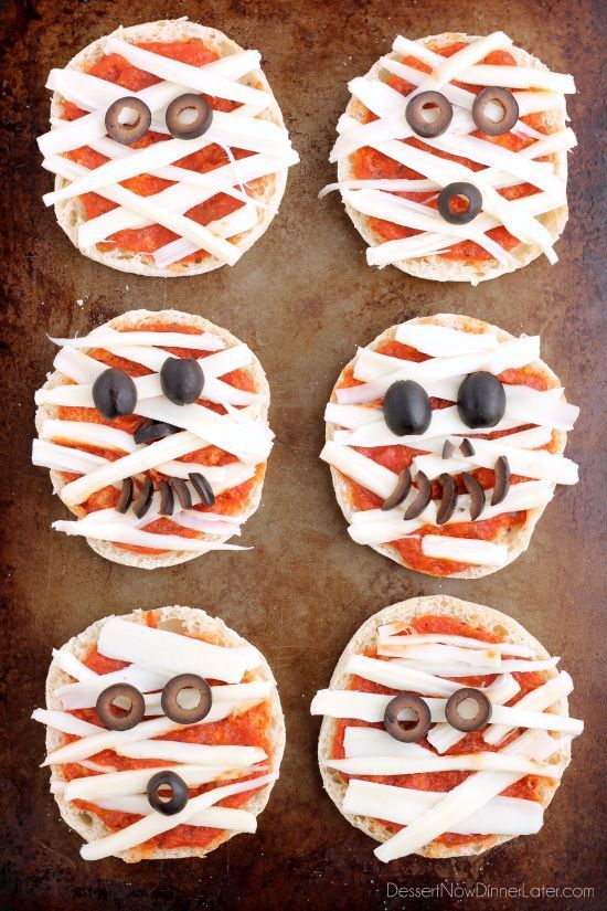 four pizzas decorated to look like faces with googly eyes