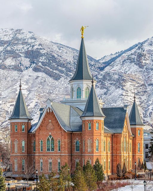 an old church in the mountains with snow on the ground