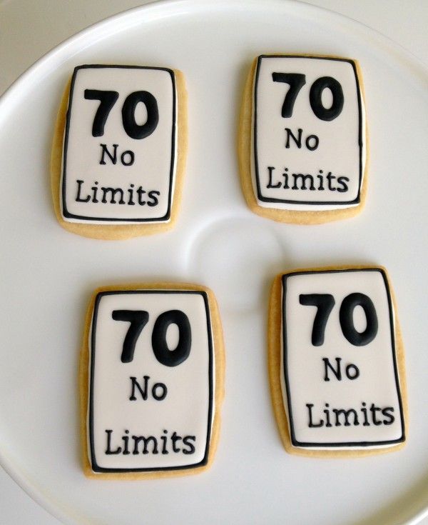 four cookies with the words 70 no limits and seventy no limits are on a plate