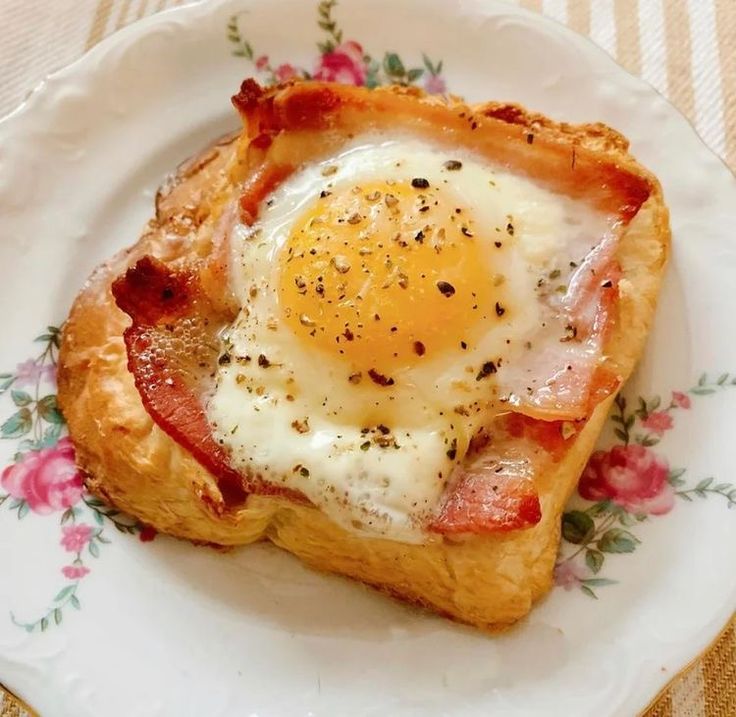 an egg and bacon pastry on a plate