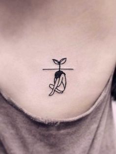 a woman's neck with a small tattoo on it