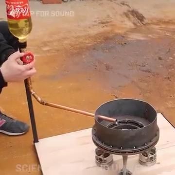 a person is pouring wine into a bucket