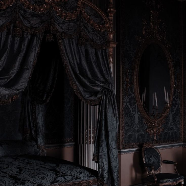 the canopy bed is made up with black sheets and drapes on it's sides