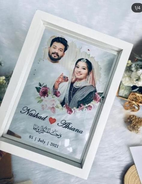 the wedding card is displayed in front of some flowers and other personalized items on a table