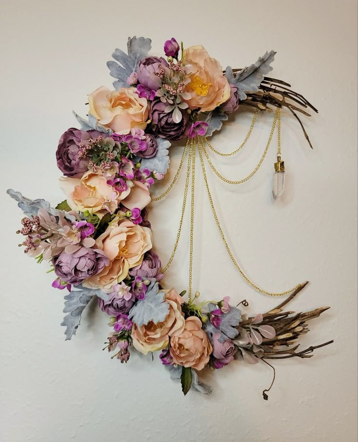 a wreath with flowers and chains hanging on the wall