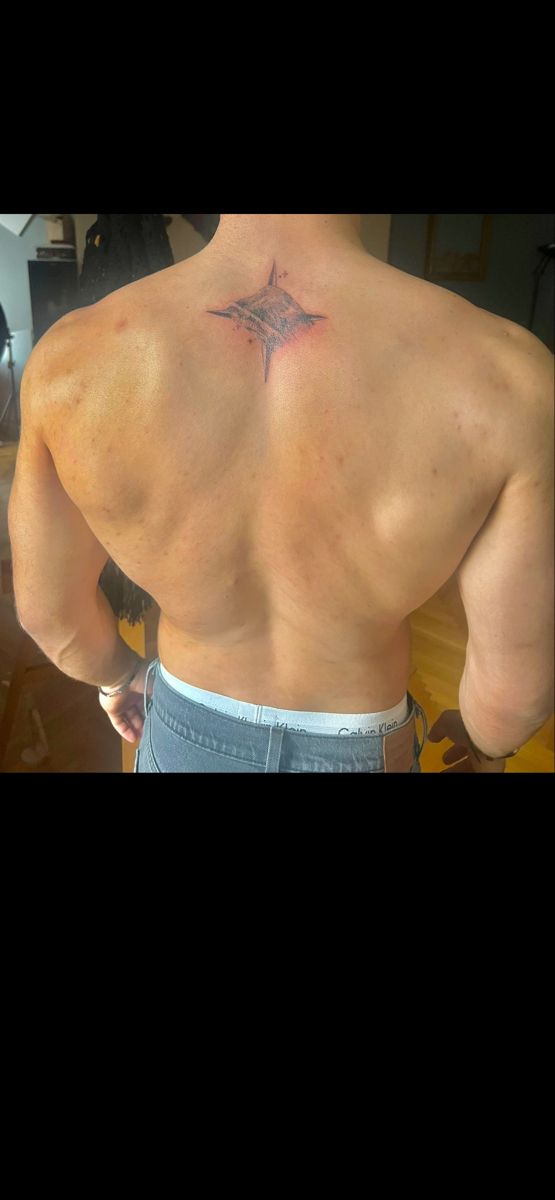 a man with a star tattoo on his back