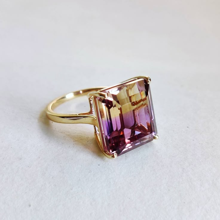 ITEM DESCRIPTION: --> The ring is made from Solid 14K Yellow Gold. Gemstone used is absolutely natural and ethically sourced. --> Ametrine is naturally occurring gemstone which is a unique combination of Amethyst and Citrine. --> Ametrine in Emerald Cut is studded on it with utmost precision. Gem: Ametrine Gem size: 12.3x14mm Gem weight: 12.18 carat Gold purity: 14K (58.33% approx.) Gold weight: 2.40 grams Gross weight of ring: 4.84 grams >>The Gold purity is guaranteed and it comes with authent Ametrine Engagement Ring, Elegant Multi-stone Amethyst Ring Gift, Oval Ruby Engagement Ring, Luxury Gold Multi-stone Amethyst Ring, Gold Luxury Amethyst Multi-stone Ring, Luxury Gold Amethyst Multi-stone Ring, Ametrine Jewelry, Ametrine Ring, Amethyst Rings