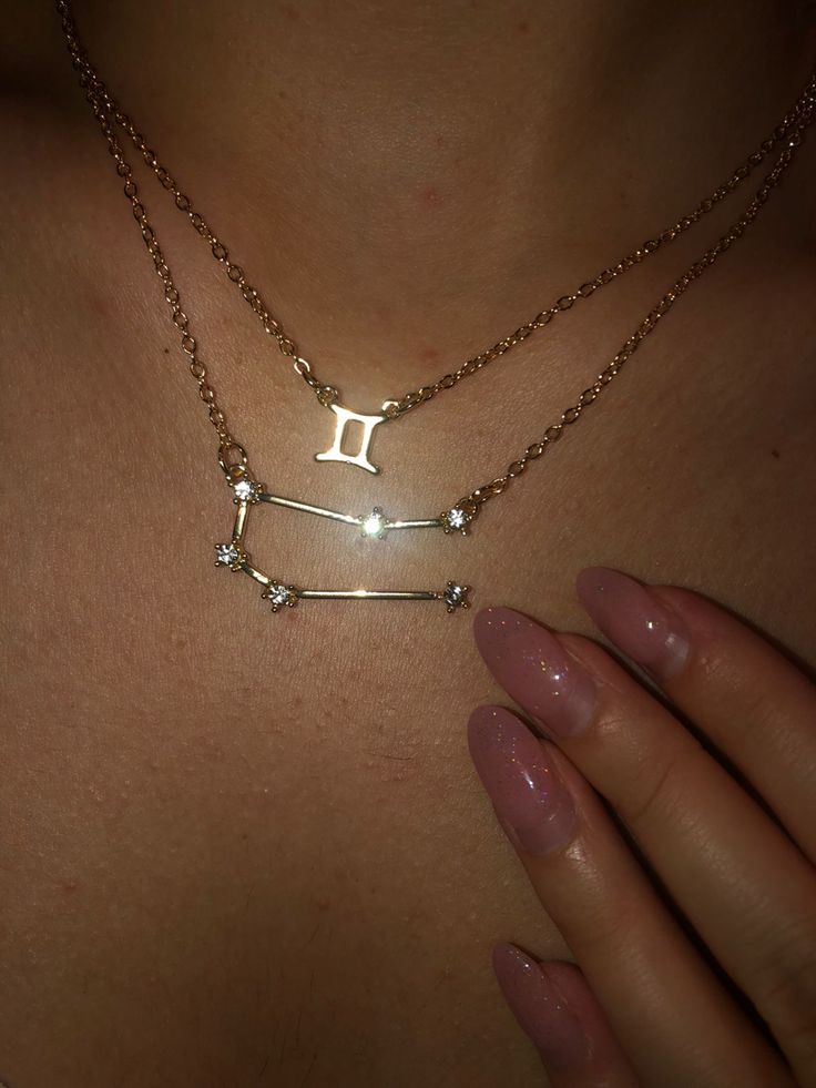 a woman wearing a necklace with the letter i on it