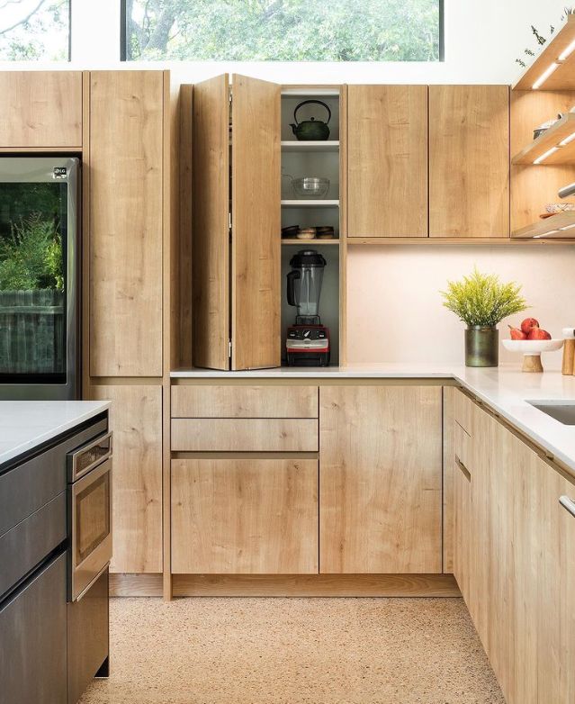 a kitchen with wooden cabinets and stainless steel appliances