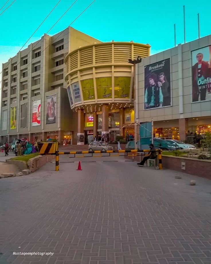 an empty street in front of a large building