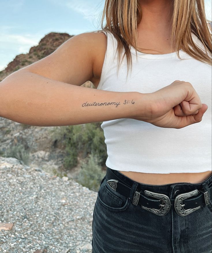 a woman with a small tattoo on her arm