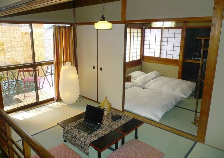 a room with two beds and a tv on the table in front of it's mirror