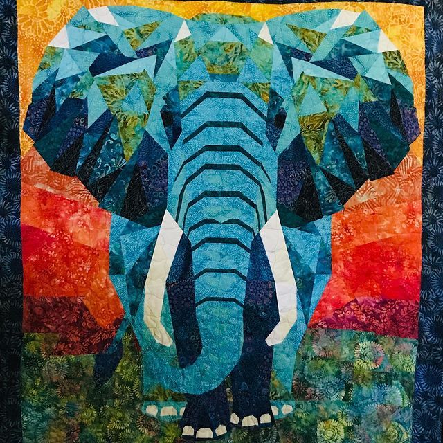 an elephant is depicted in this colorful quilt