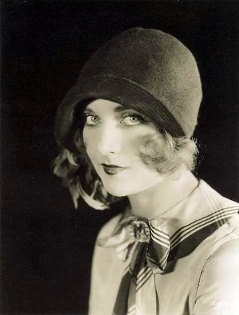 black and white photograph of a woman wearing a hat