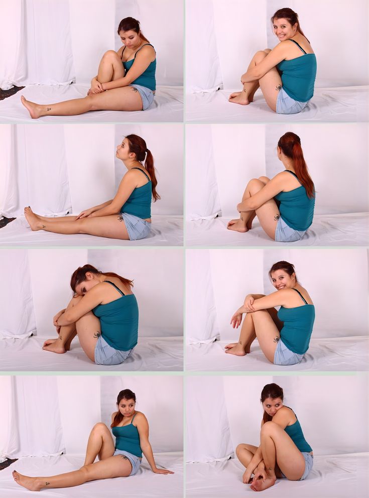 a woman is sitting on the floor with her legs spread out and posing for pictures