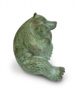 a green statue of a bear sitting on its hind legs and looking to the side