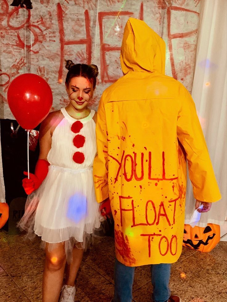 a man and woman dressed in costumes standing next to each other with balloons around them