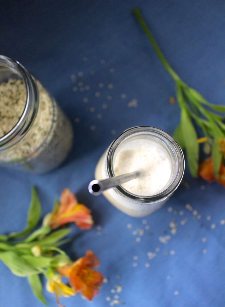 two mason jars filled with oatmeal sitting on top of a blue table