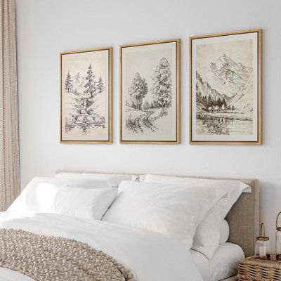 a bedroom with three paintings on the wall above the bed