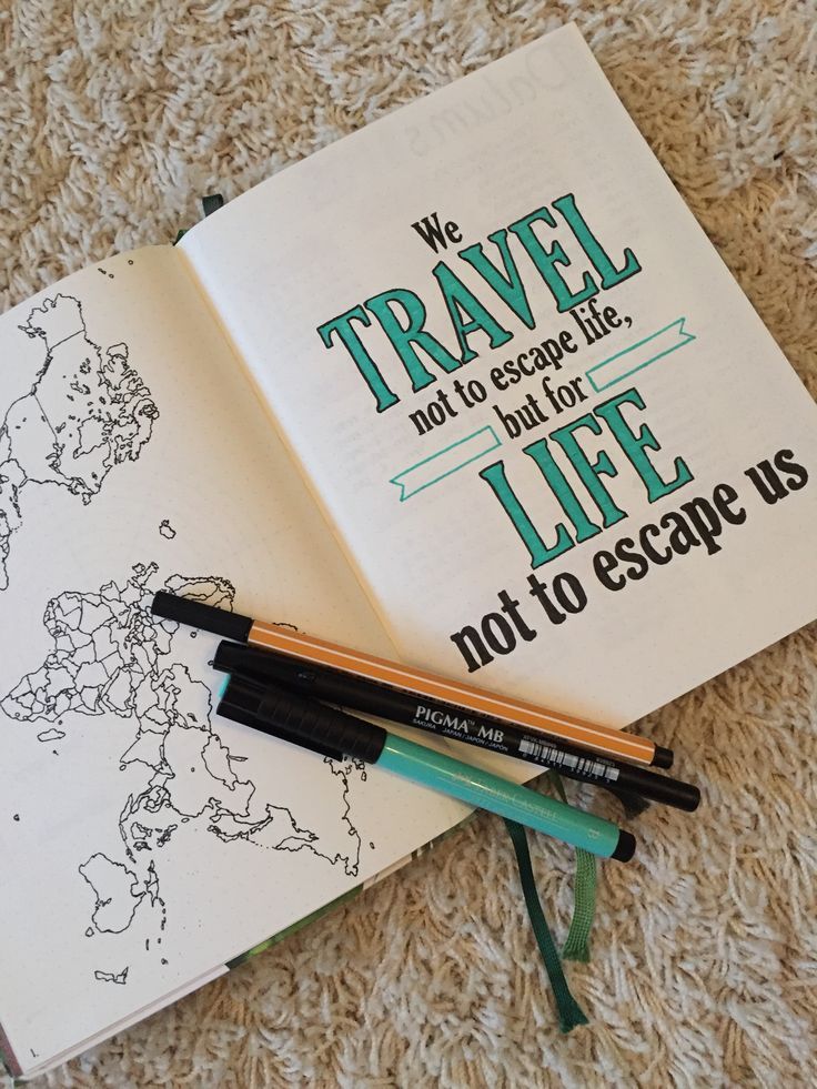 an open book on the floor with some pens and markers next to it that says we travel not to escape life, not to escape us