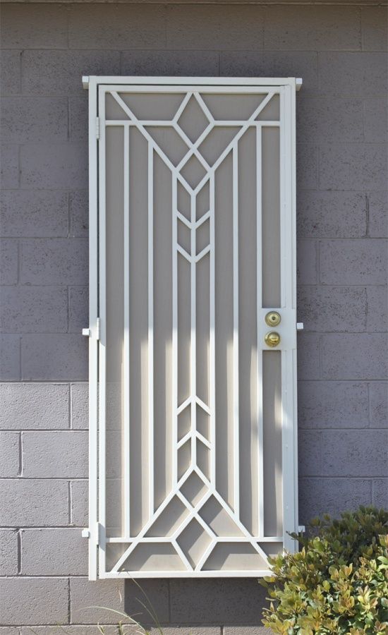 an iron work sign is displayed on the side of a building in front of a door