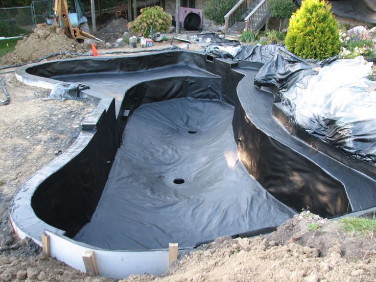 an outdoor swimming pool is being constructed in the dirt and surrounded by plastic tarps