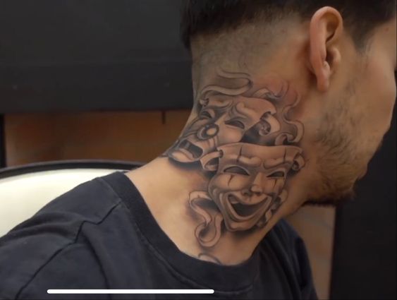 a man with a tattoo on his neck and behind the neck is an image of a mask