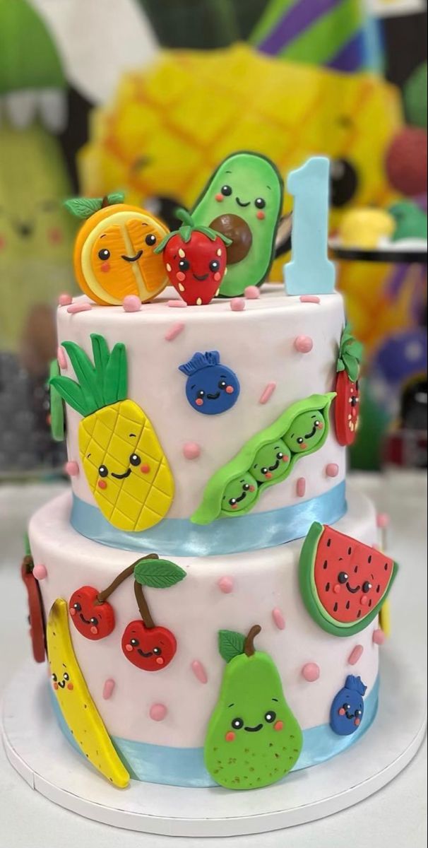 a three tiered cake decorated with fruit and vegetables