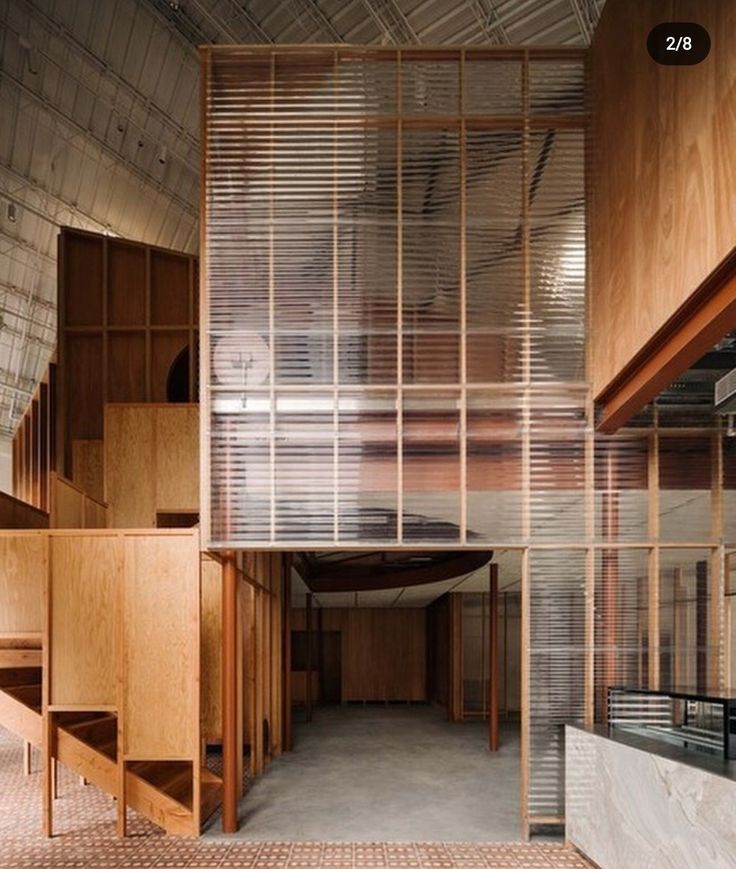 the inside of an empty building with wooden stairs