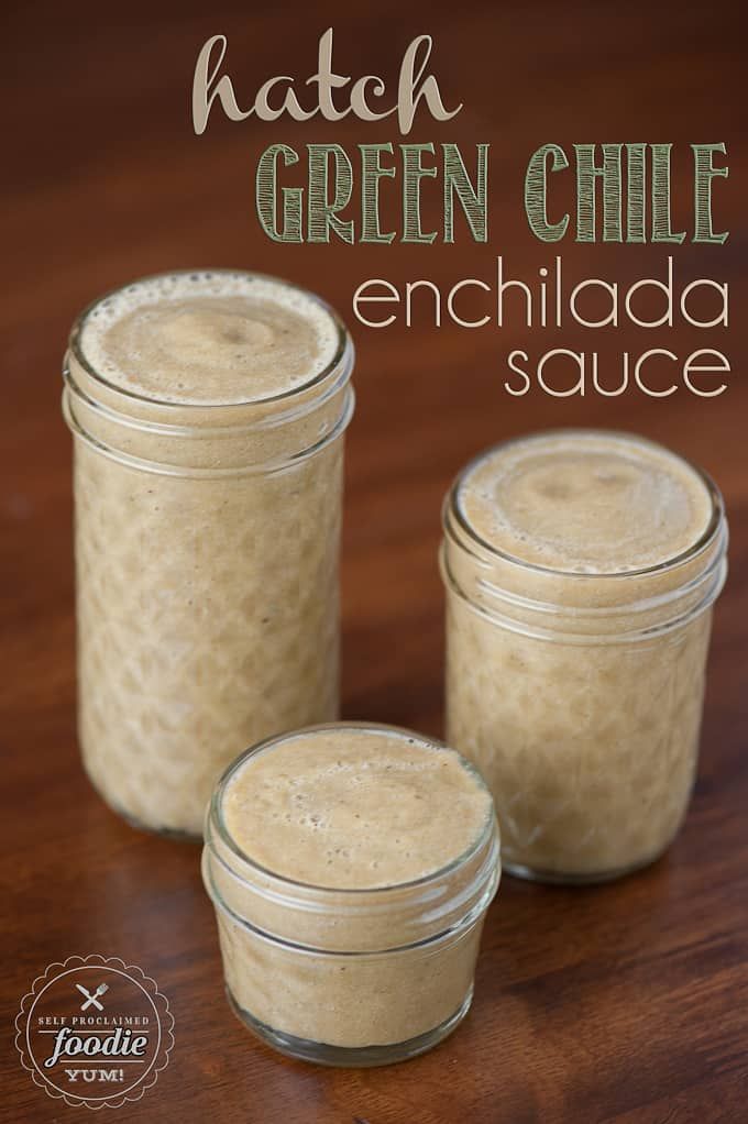 three jars filled with green chile enchilada sauce on top of a wooden table