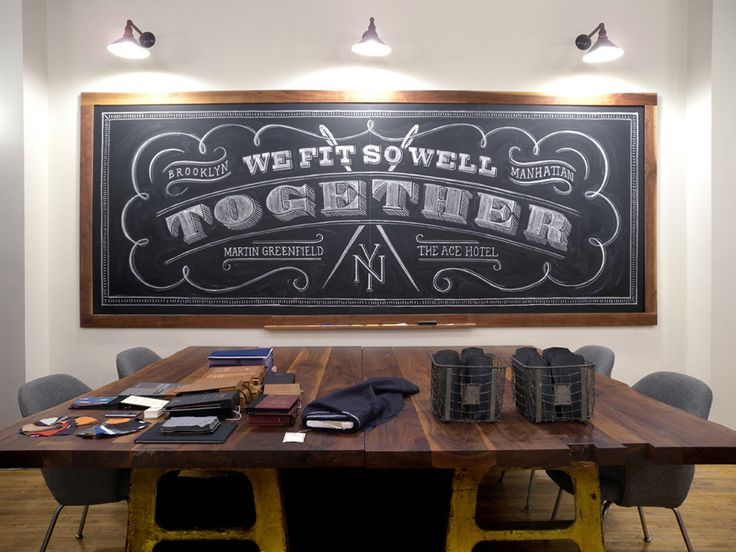 a wooden table sitting in front of a chalkboard with writing on it that says we fit sowell together