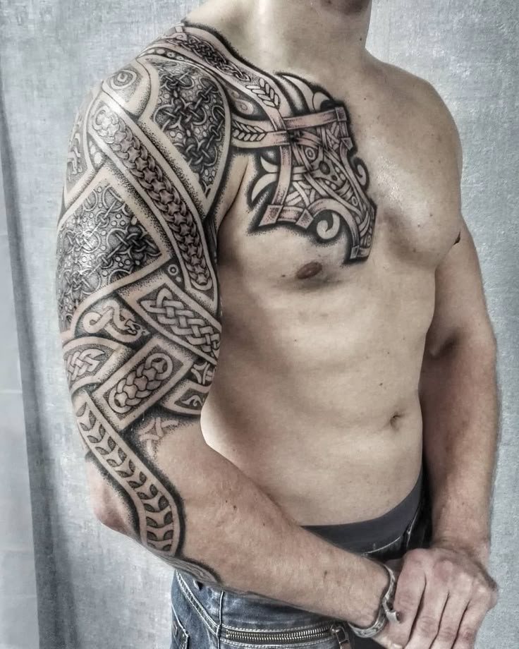 a man with a tattoo on his arm and chest