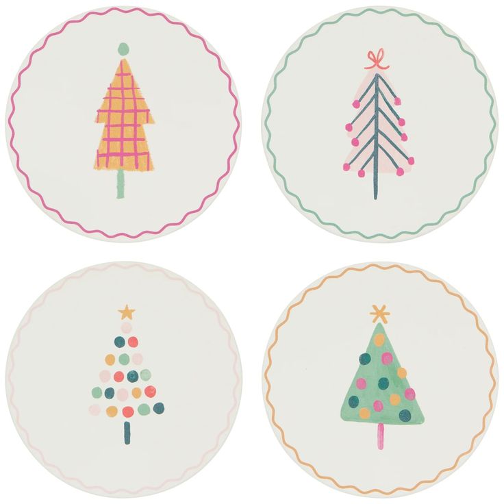 four plates with christmas trees on them in different colors and designs, each decorated with colorful dots