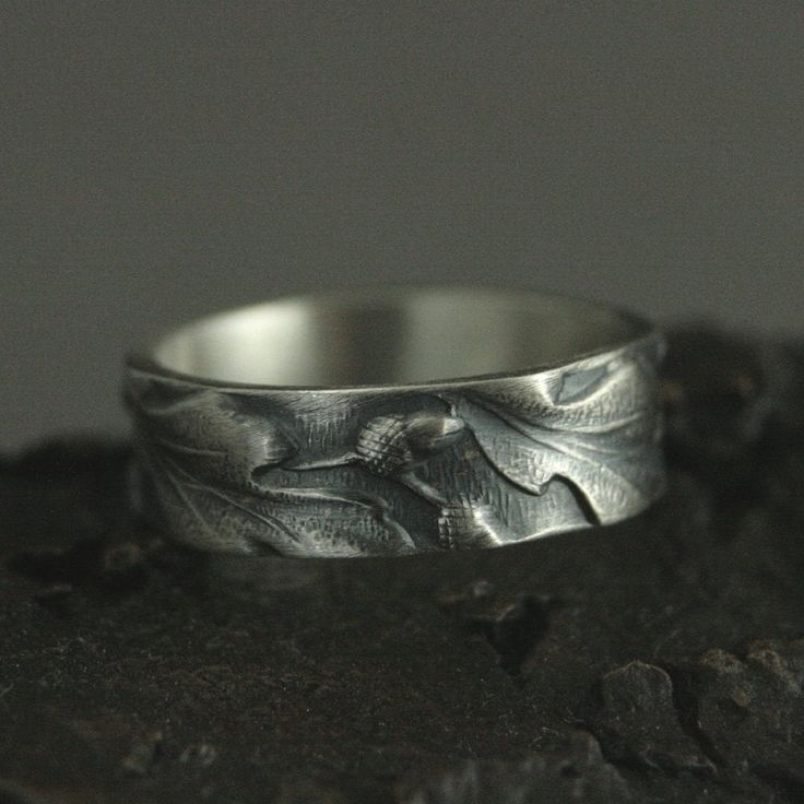 Band Tree Ring Nature Inspired Band Oak Leaf Ring Acorns Band Embossed Ring Silver Promise Band 6mm Oak Ring Silver Pattern Band Blazer Arts ☆ MATERIALS: Sterling Silver ☆ DIMENSIONS: 6mm Wide by 1.5mm Thick Our modern lives are hectic and we are inundated with so much technology that it's easy to think we are separate from nature. We understand that it can be difficult to take the time to get back to nature, and our sterling Oaken Band offers you a way to take it with you wherever you go. This Promise Band, Tree Ring, Tree Rings, Palm Coast, Leaf Ring, Oak Leaf, Woodland Wedding, Back To Nature, Sterling Silver Bands