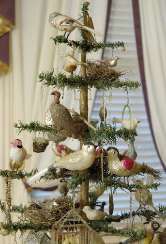 a christmas tree decorated with birds and ornaments