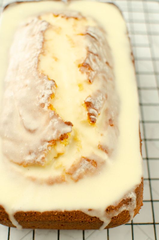 a loaf of bread with white icing on a cooling rack