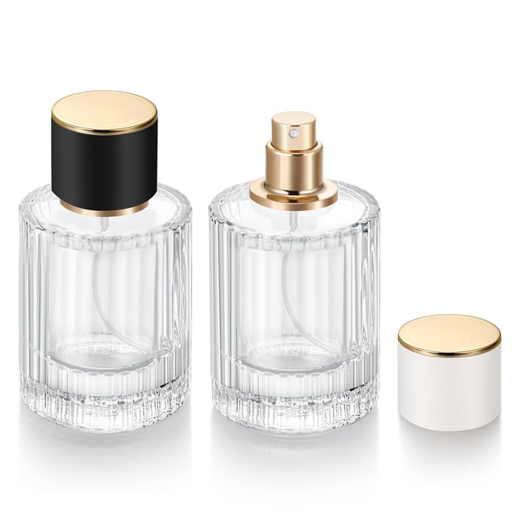 three glass bottles with gold lids and one empty bottle next to each other on a white surface