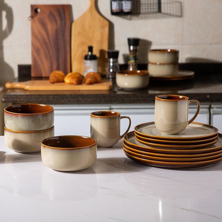 a kitchen counter with plates and cups on it